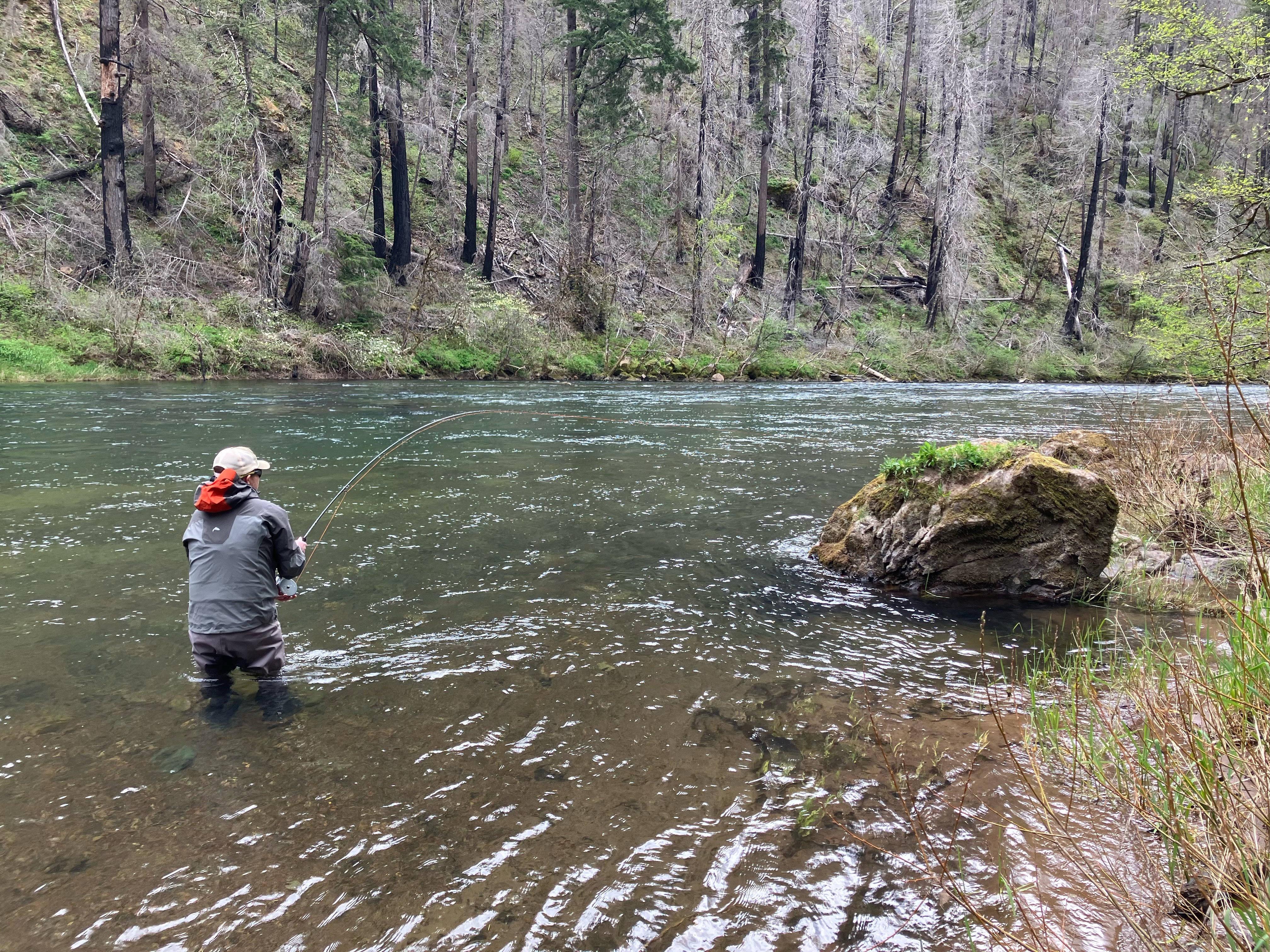 Angler casting on mountain river